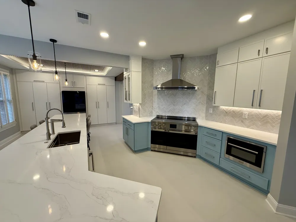 Light blue cabinetry and pale flooring in a freshly remodeled kitchen — angled view.